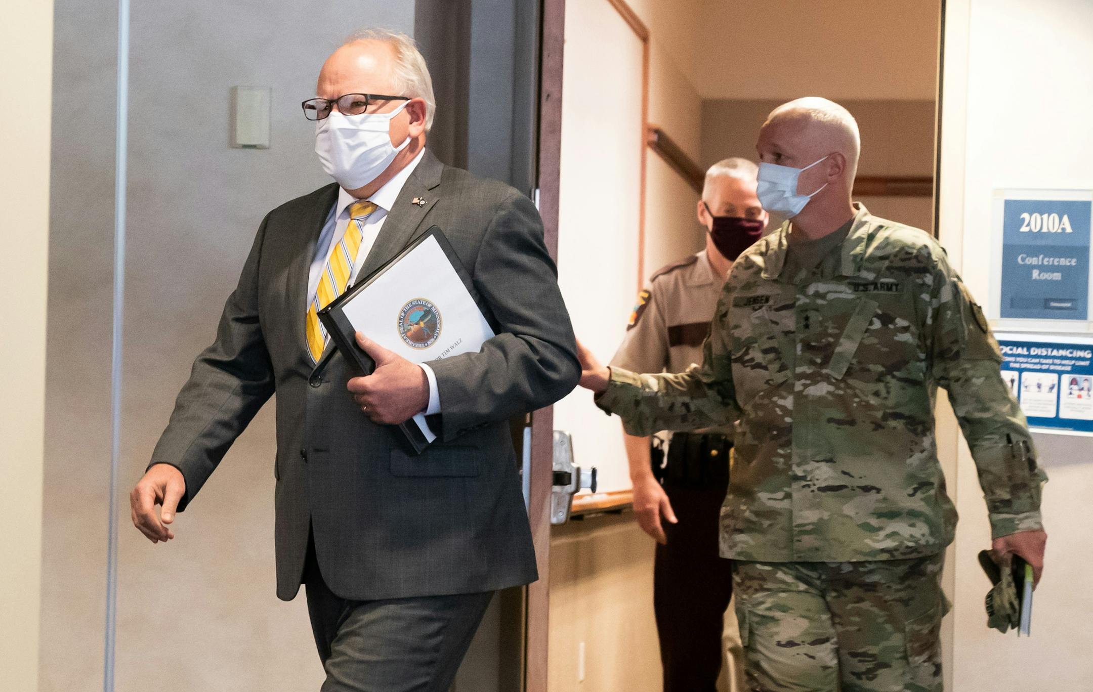 Governor Tim Walz walked into a press conference about the unrest in the wake of the death of George Floyd while he was in custody of Minneapolis police. Behind him are Maj. Gen. Jon Jensen, adjutant general of the Minnesota National Guard and Minnesota State Patrol Colonel Matt Langer. ] GLEN STUBBE • glen.stubbe@startribune.com Friday, May 29, 2020 POOL PHOTO