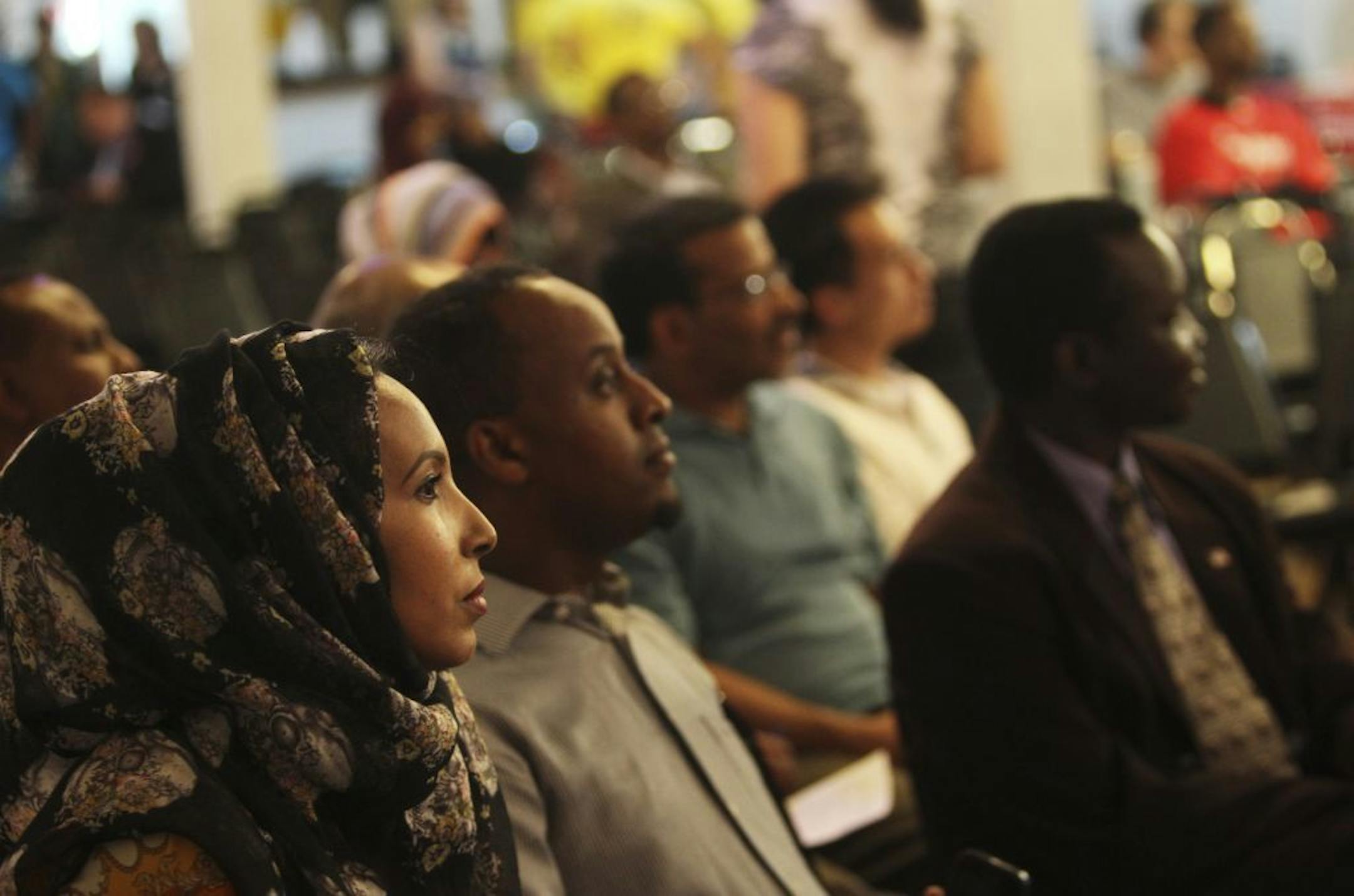 Muna Ahmed, left, was among those taking in the mayoral debate at Safari restaurant Friday, May 31, 2013, in Minneapolis, MN.