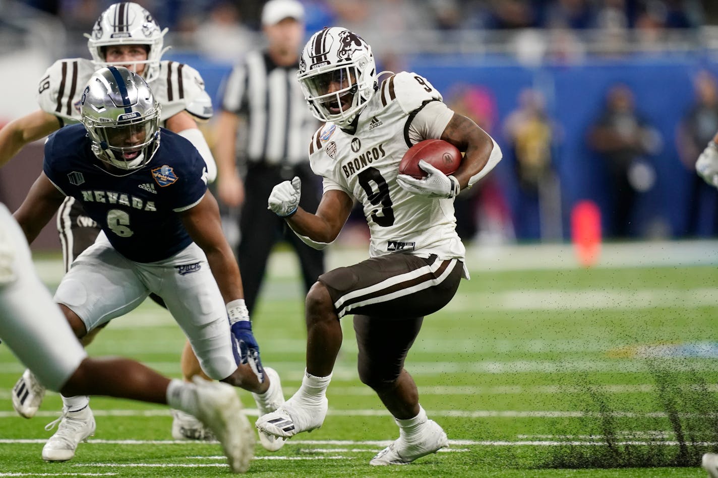 Western Michigan running back Sean Tyler (9) rushes during the first half of the Quick Lane Bowl NCAA college football game against Nevada, Monday, Dec. 27, 2021, in Detroit. (AP Photo/Carlos Osorio)