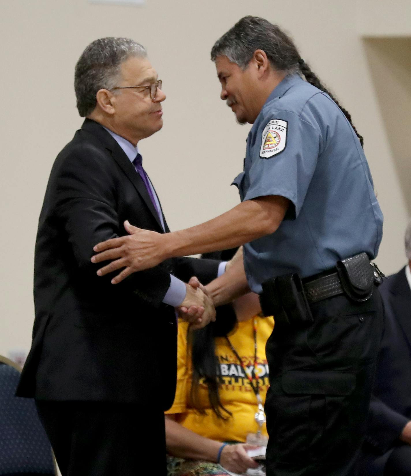 Tuesday, July 30, 2018 was dedication day for the new Bug-O-Nay-Ge- Shig School in Bena, Minnesota. Here, Mike Robinson, a Bug grad from 1976, and Tribal Assistant Police Chief, shakes hands with former U.S. Senator Al Franken during the ceremony.]
DAVID JOLES &#xef; david.joles@startribune.com Four years ago, the aging and dilapidated converted garage that served as the high school for the Leech Lake Band of Ojibwe was one of 62 Bureau of Indian Educations facilities nationwide in dire need of