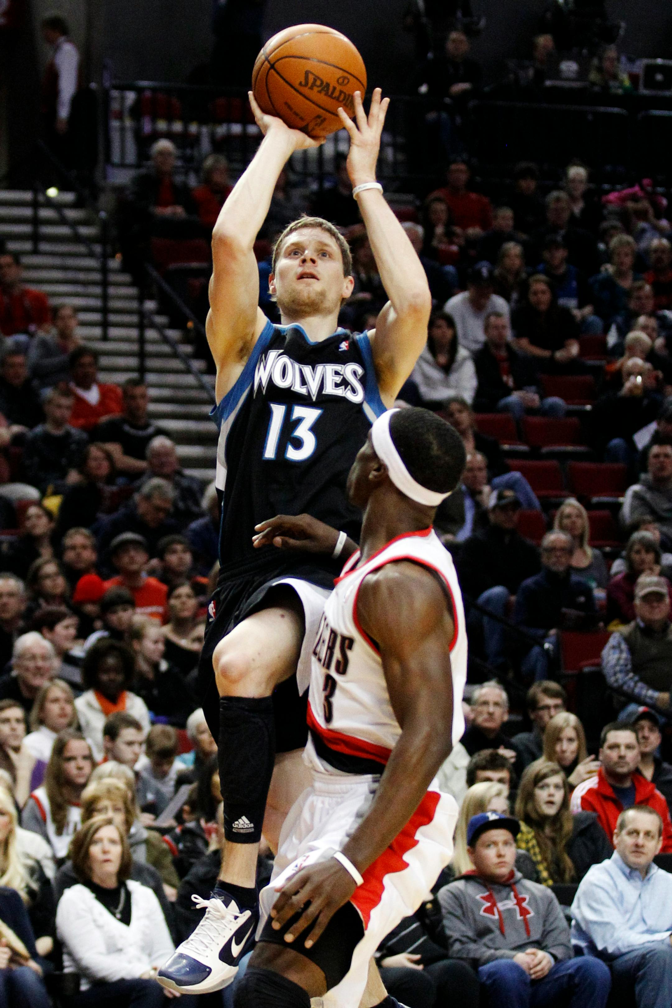 Minnesota Timberwolves' Luke Ridnour (13) shoots as Portland Trail Blazers' Jonny Flynn (3) defends in the first quarter of an NBA basketball game, Sunday, April 1, 2012, in Portland, Ore. (AP Photo/Rick Bowmer)