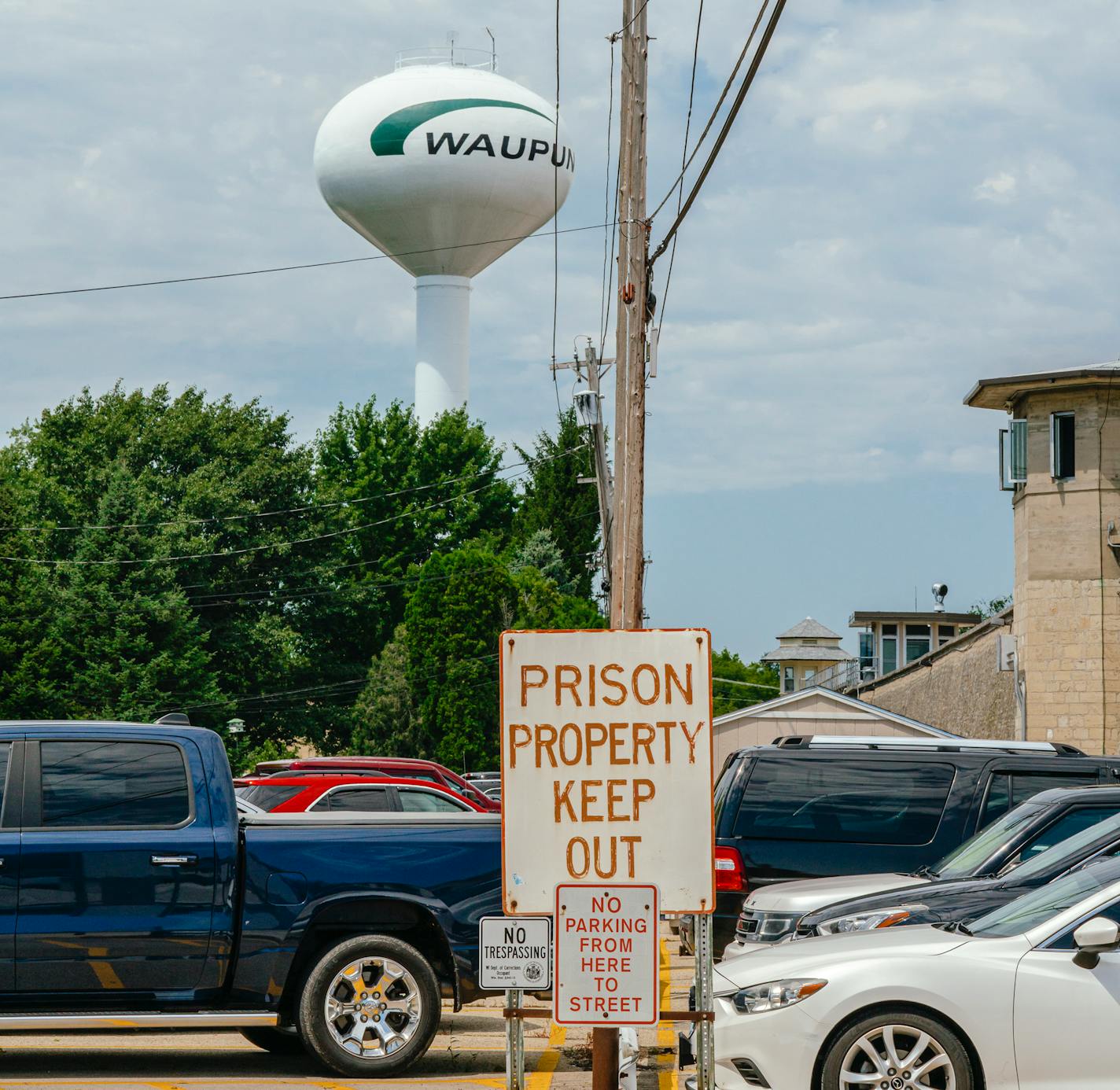 A sign marking Waupun Correctional Institution property in downtown Waupun, Wis. on July 27, 2023. Unlike the many penitentiaries built in remote areas, WaupunÕs prison sits in the middle of town, next to the public library and on a quaint main street. (Jamie Kelter Davis/The New York Times)