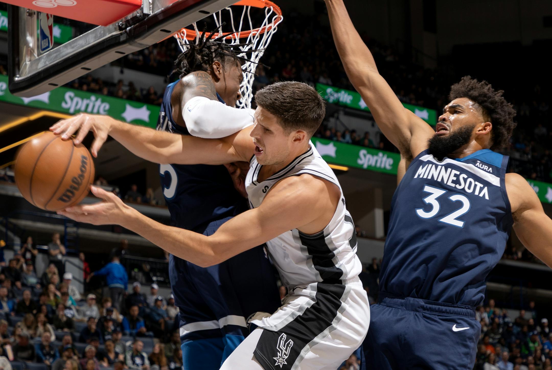 Jaden McDaniels (3) and Karl Anthony-Towns (32) of the Minnesota Timberwolves defended Doug McDermott of the San Antonio Spurs in the third quarter Wednesday, October 26, 2022, at Target Center in Minneapolis, Minn.
