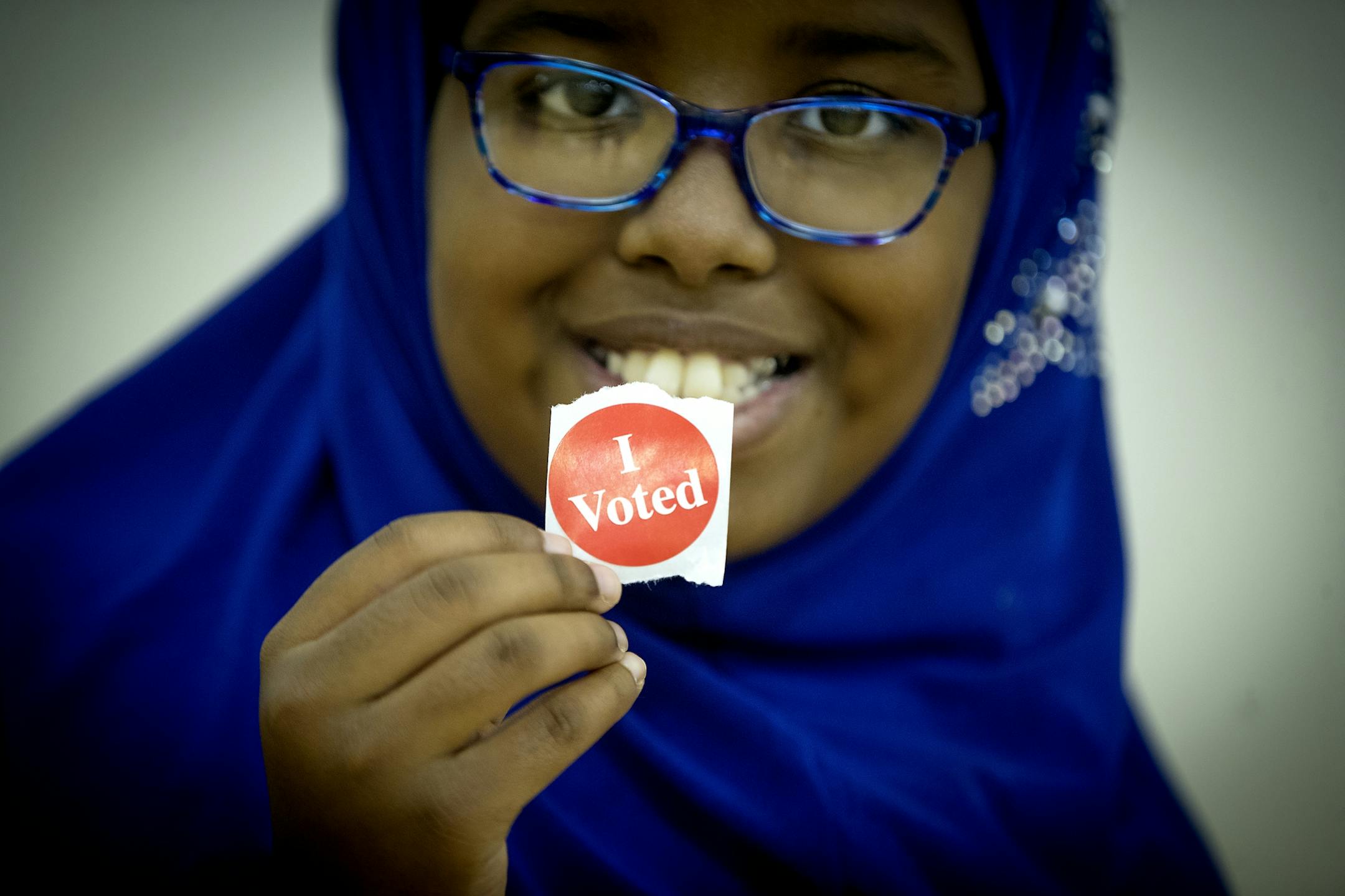 Amina Said proudly held up her mother's "I voted" sticker after her mother Weris Said voted at the Brian Coyle Community Center on primary election day, Tuesday, August 14, 2018 in Minneapolis MN.
