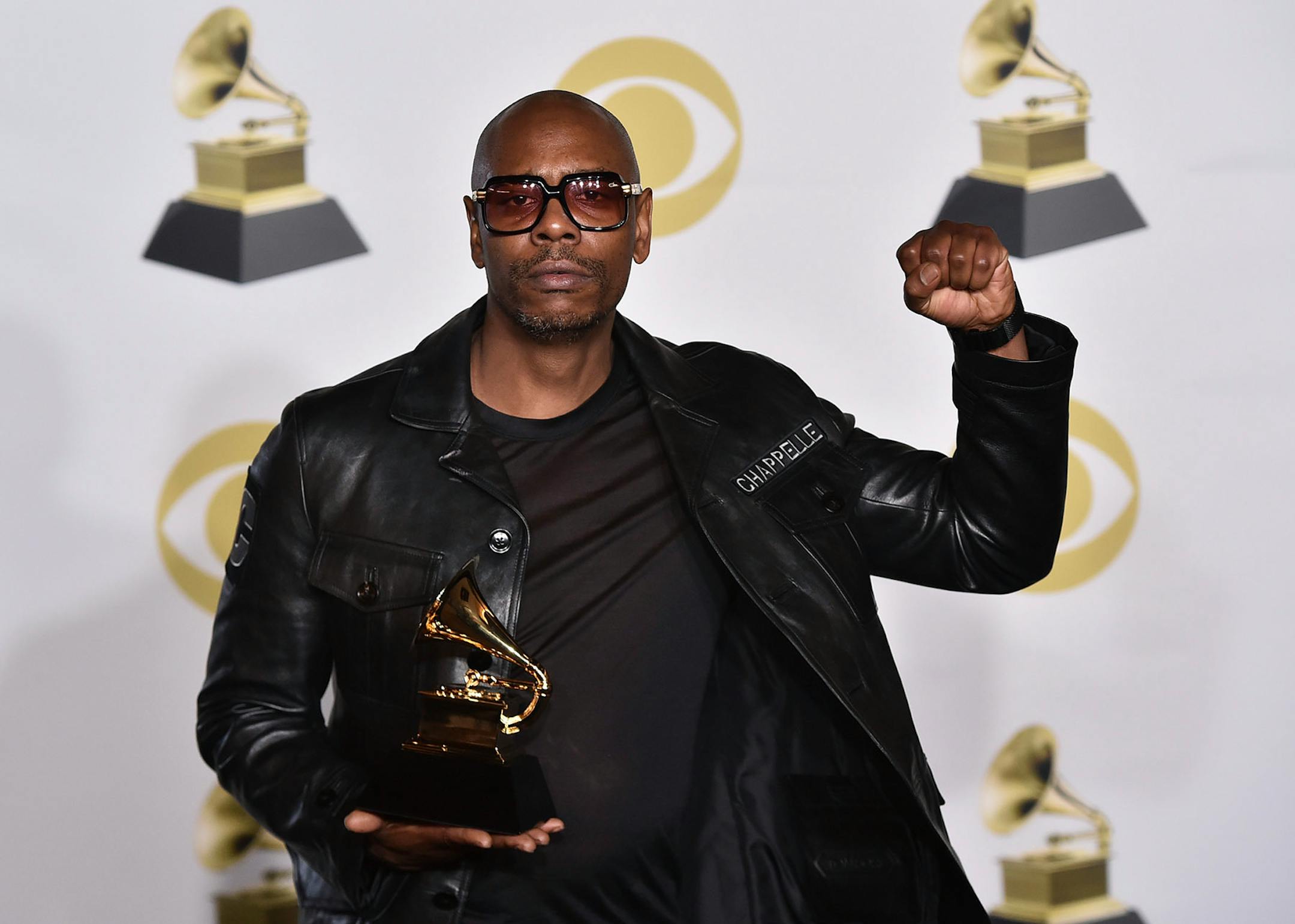 Dave Chappelle poses in the press room with the best comedy album award for "The Age of Spin" and "Deep in the Heart of Texas" at the 60th annual Grammy Awards at Madison Square Garden on Sunday, Jan. 28, 2018, in New York.