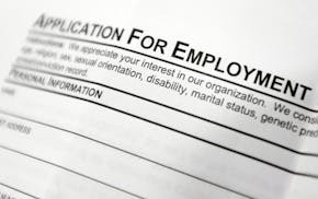 FILE - This April 22, 2014, file photo shows an employment application form on a table at a job fair in Hudson, N.Y. Middle-age white Americans with l