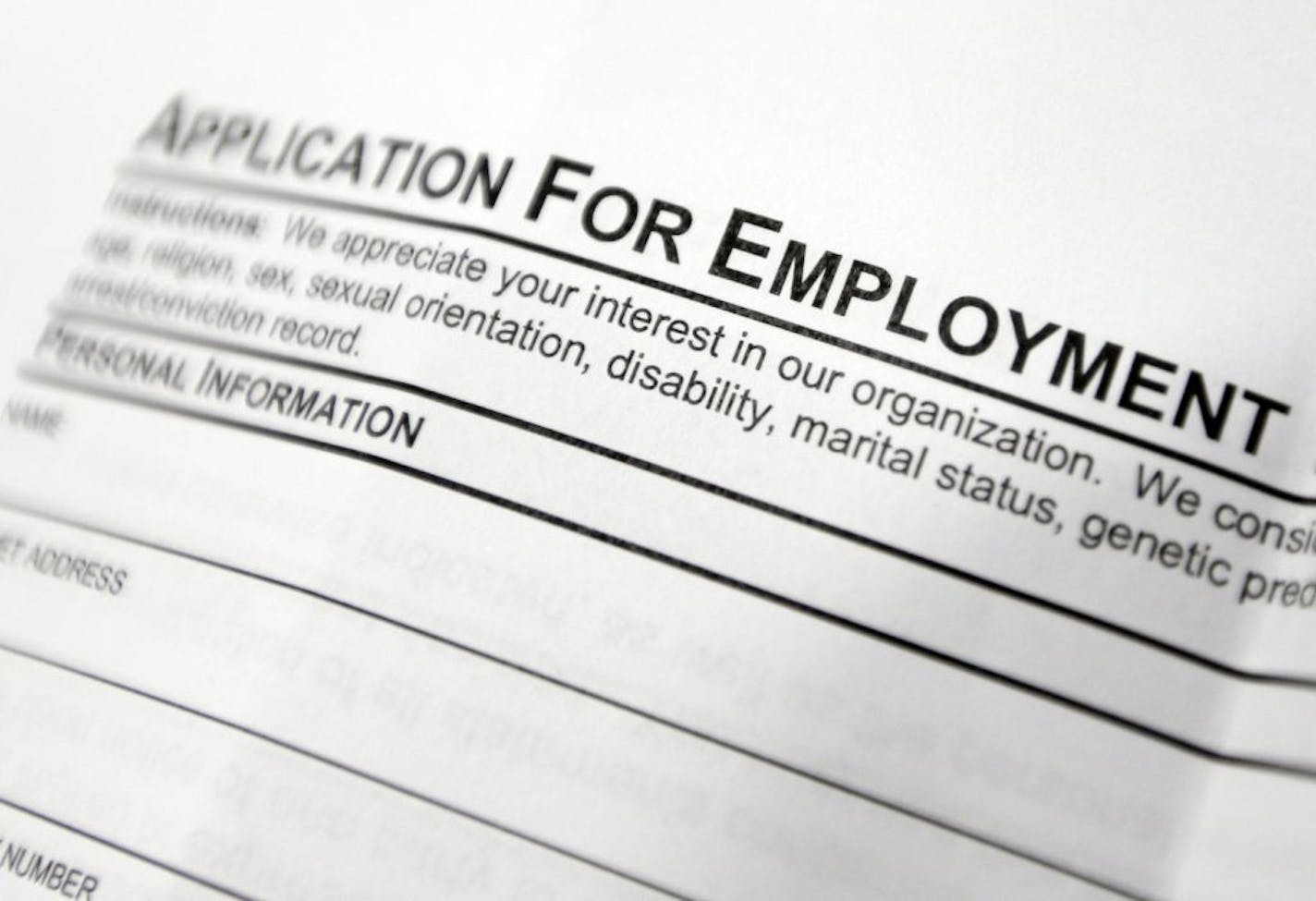 FILE - This April 22, 2014, file photo shows an employment application form on a table at a job fair in Hudson, N.Y. Middle-age white Americans with limited education are increasingly dying younger, on average, than other middle-age U.S. adults, a trend driven by their dwindling economic opportunities, research by two Princeton University economists has found. The economists, Anne Case and Angus Deaton, argue in a paper released Thursday, March 23, 2017, that the loss of steady middle-income job