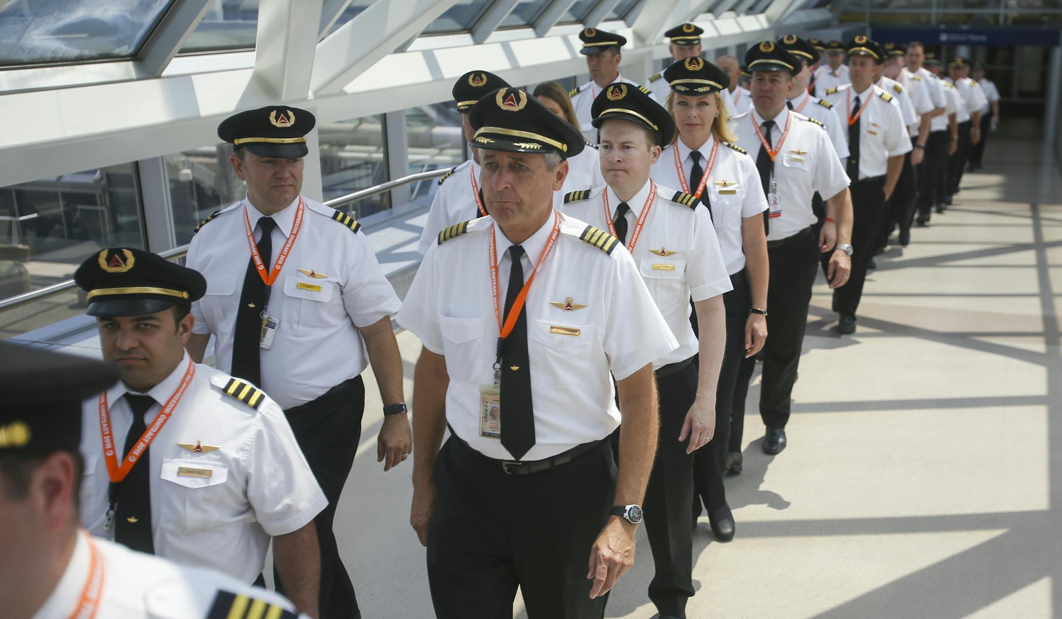 Pilots from Delta Air Lines march through a skyway into the baggage check in. ] Timothy Nwachukwu &#x2022; timothy.nwachukwu@startribune.com Pilots from Delta Air Lines picketed outside Terminal 1 of Minneapolis&#x2013;Saint Paul International Airport on Friday, June 24, 2016. Pilots were protesting in order to raise awareness of a lack of salary increases and negotiations between the pilots' union and the company since talks began on March 31, 2016.