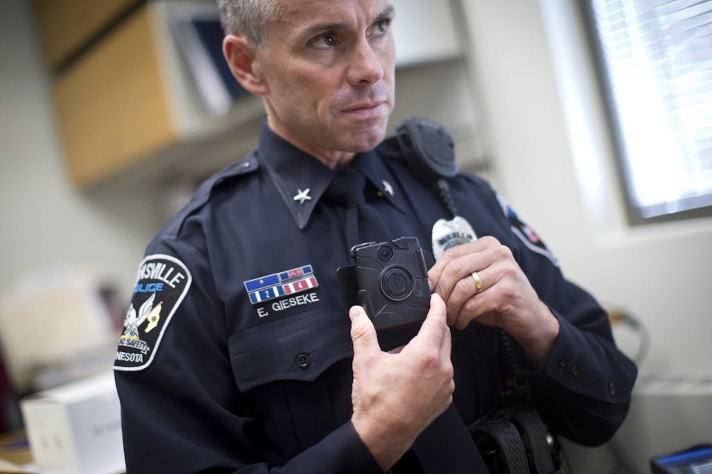 Chest-mounted recorder: Burnsville Police Chief Eric Gieseke showed how an officer wears a chest-style body camera. This is the third year the department has used cameras worn by officers.