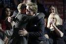 Brock Boeser, center, is hugged as he walks to the stage after being chosen 23rd overall by the Vancouver Canucks during the first round of the NHL ho