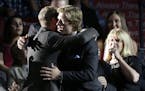 Brock Boeser, center, is hugged as he walks to the stage after being chosen 23rd overall by the Vancouver Canucks during the first round of the NHL ho