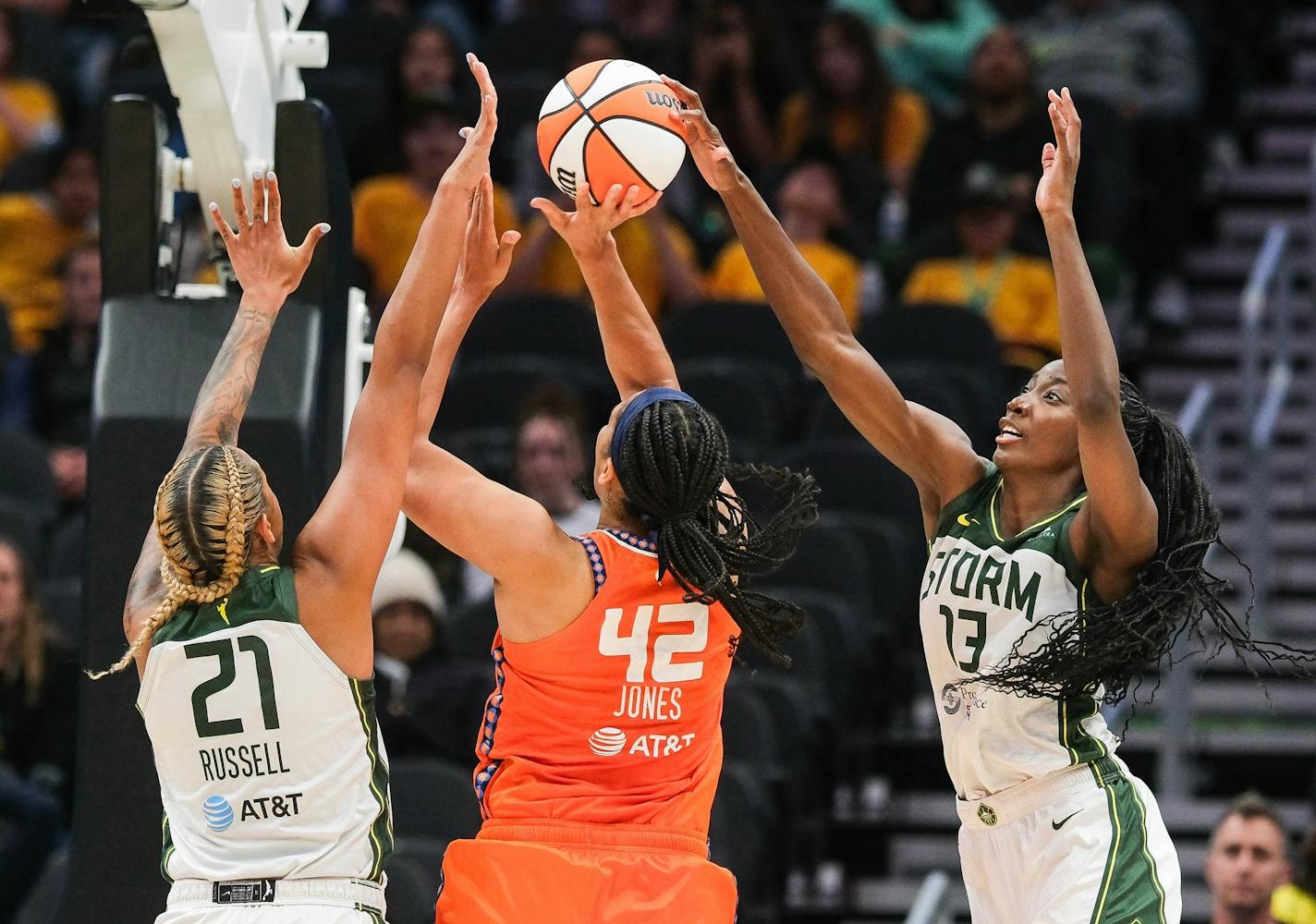 Seattle Storm's Ezi Magbegor, right, gets a hand on the shot by Connecticut's Brionna Jones during the fourth quarter of a WNBA basketball game Tuesday, June 20, 2023, in Seattle. At left is Storm's Mercedes Russell. (Dean Rutz/The Seattle Times via AP)