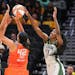Seattle Storm's Ezi Magbegor, right, gets a hand on the shot by Connecticut's Brionna Jones during the fourth quarter of a WNBA basketball game Tuesda