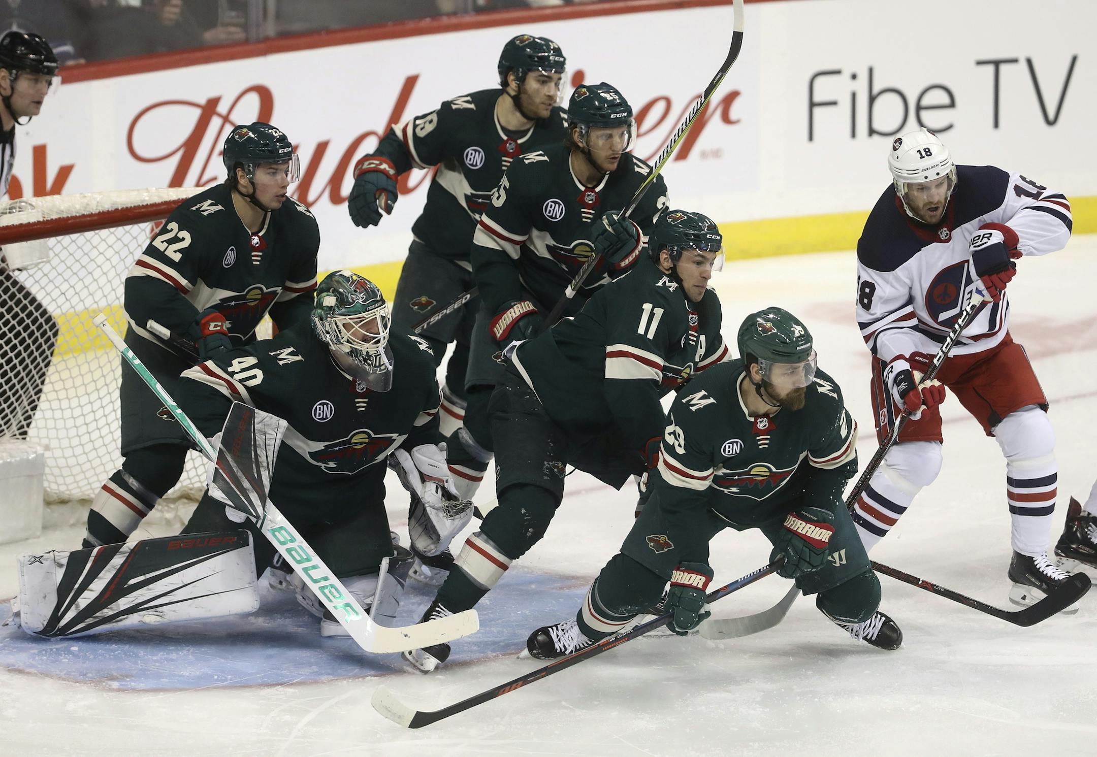 Minnesota Wild's Kevin Fiala (22), goaltender Devan Dubnyk (40), Luke Kunin (19), Jonas Brodin (25), Zach Parise (11) and Greg Pateryn (29) gather in front of the net as Winnipeg Jets' Bryan Little (18) looks for the puck during the first period of an NHL hockey game Tuesday, Feb. 26, 2019, in Winnipeg, Manitoba. (Trevor Hagan/The Canadian Press via AP)