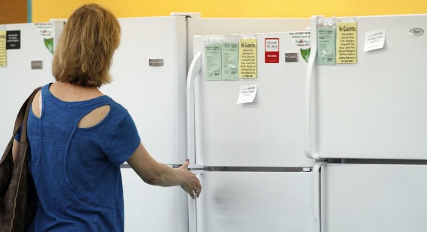 In this April 27, 2012, photo a customer inspects a refrigerator at a Cowboy Maloney's Electric City Superstore in Jackson, Miss. Orders for durable goods increased a slight 0.2 per cent last month after a 3.7 per cent decline in March, the Commerce Department said Thursday, May 24, 2012.