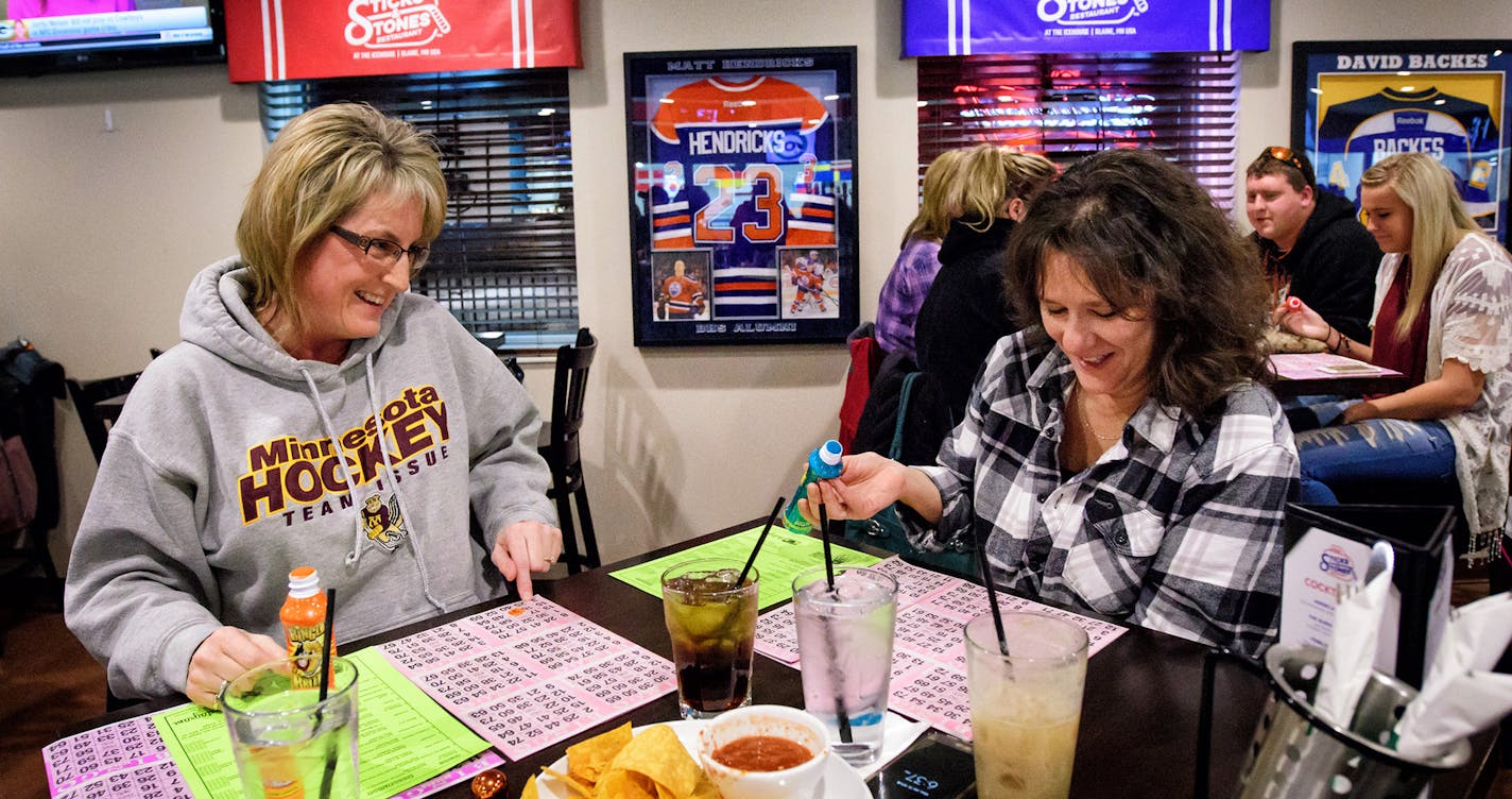 Lisa Paal and Debbie Dodge, friends and sisters-in-law played bingo at Sticks and Stones Sports Bar in Blaine. ] GLEN STUBBE * gstubbe@startribune.com Monday January 16, 2017 Minnesota Wild tickets bingo night, sponsored by Spring Lake Park Lions at Sticks and Stones Sports Bar in Blaine. With women from around the country traveling to Washington to protest Donald Trump's inauguration, we'll talk to women who are excited for Trump's presidency - or at least, are ready to give the new president a