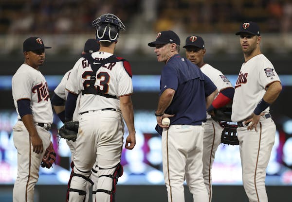 Minnesota Twins manager Paul Molitor waits for reliever Matt Belisle to arrive at the mound after he pulled Matt Magill in the sixth inning against th