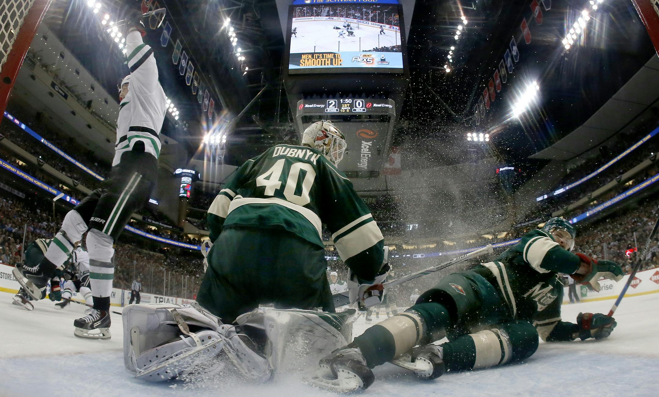 Jamie Benn (14) celebrated a goal by Patrick Sharp (10) in the first period. The puck got past Wild goalie Devan Dubnyk (40) for the goal and Nate Prosser (39) slid into the net soon after. ] CARLOS GONZALEZ cgonzalez@startribune.com - April 24, 2016, St. Paul, MN, Xcel Energy Center, NHL, Hockey, Minnesota Wild vs. Dallas Stars, First Round Stanley Cup Playoffs, Game 6