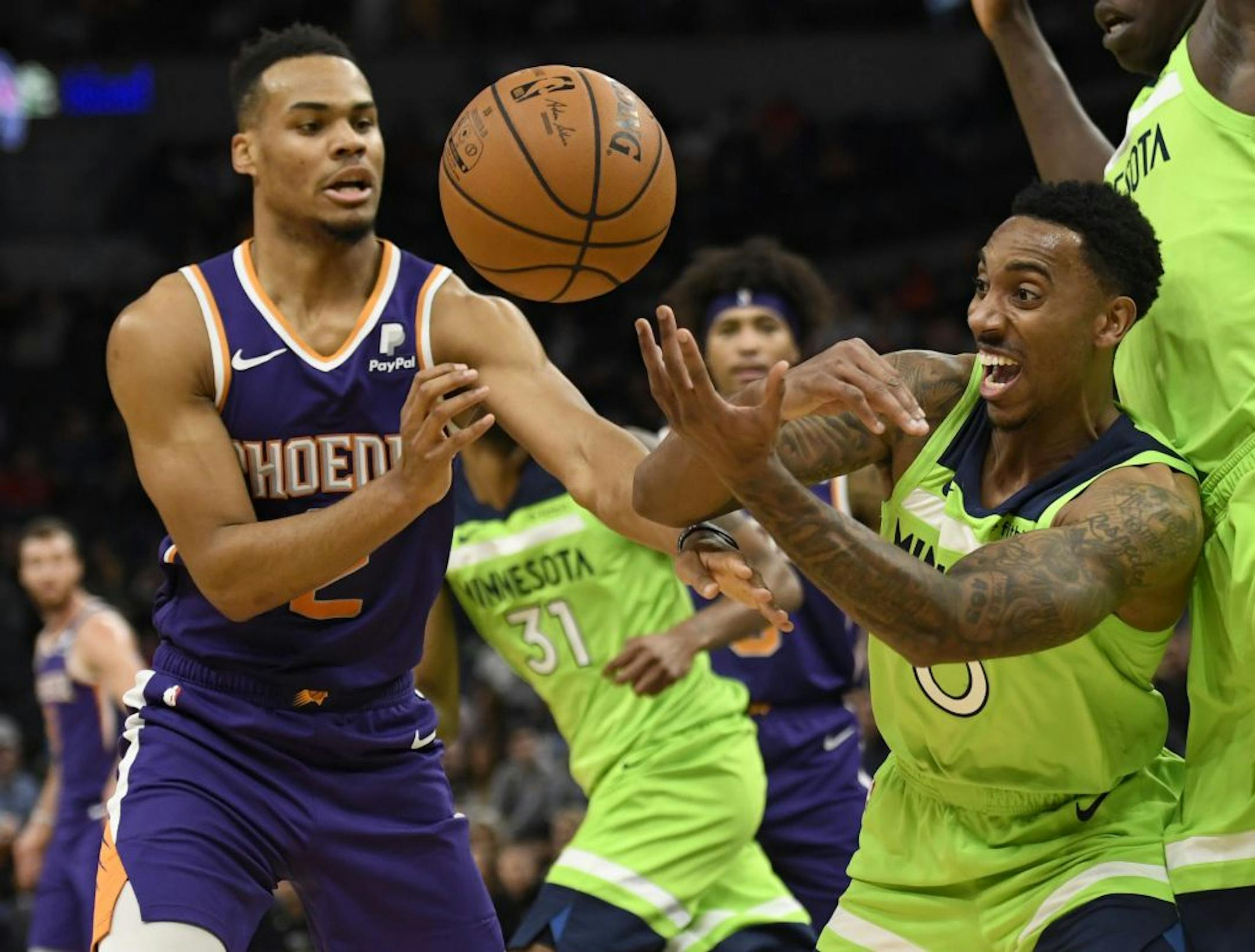 Phoenix Suns' Elie Okobo, left, and Minnesota Timberwolves' Jeff Teague go after the ball during the second quarter of an NBA basketball game Saturday, Nov. 23, 2019, in Minneapolis.