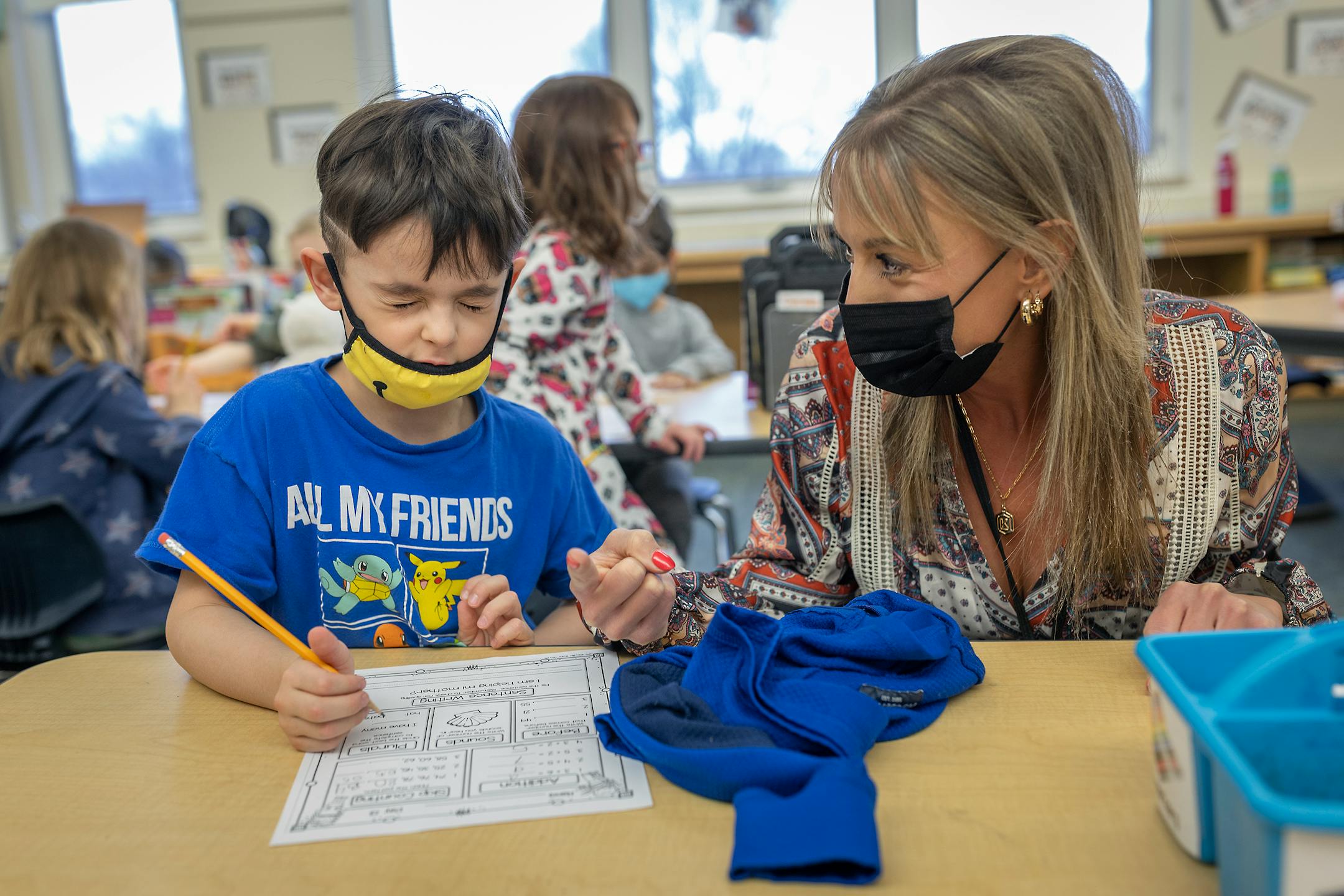 Kindergarten teacher works with student