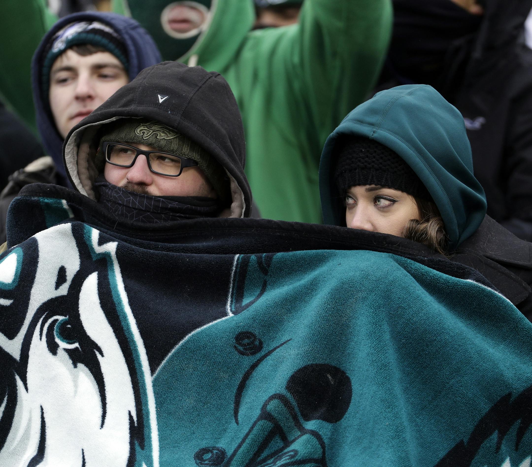 Philadelphia Eagles' fans huddle during the second half of an NFL football game against the Dallas Cowboys, Sunday, Dec. 31, 2017, in Philadelphia. (AP Photo/Chris Szagola)
