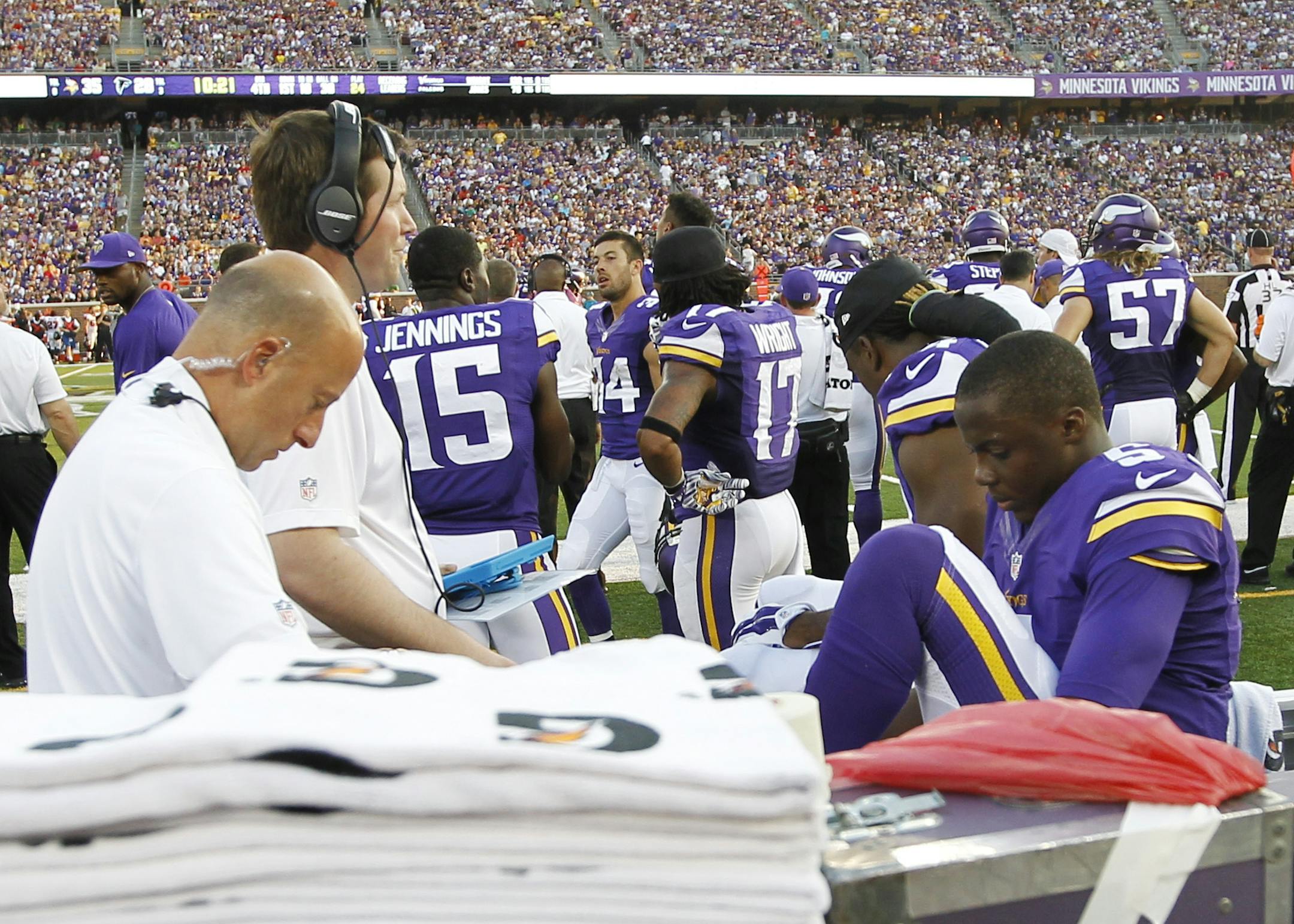 Minnesota Vikings quarterback Teddy Bridgewater (5) is attended to by a trainer on the bench after getting injured during the second half of an NFL football game against the Atlanta Falcons, Sunday, Sept. 28, 2014, in Minneapolis. (AP Photo/Ann Heisenfelt)