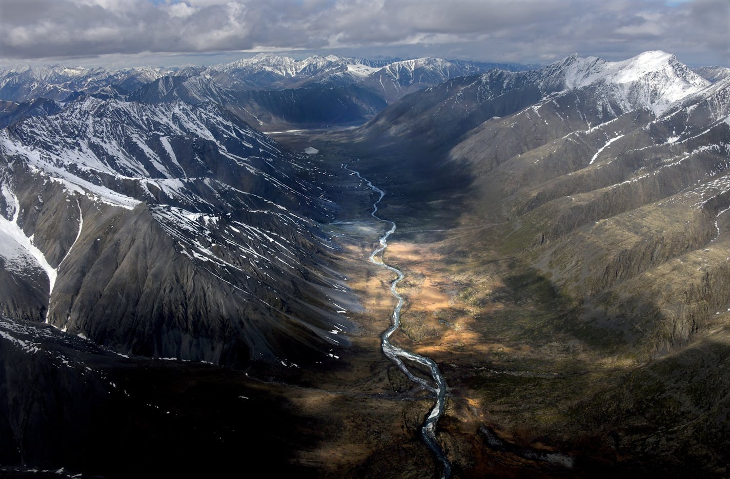 Caption: Flying into the Arctic National Wildlife Refuge by bush plane takes one directly over the impressive Brooks Mountain Range and majestic Canning River Valley.