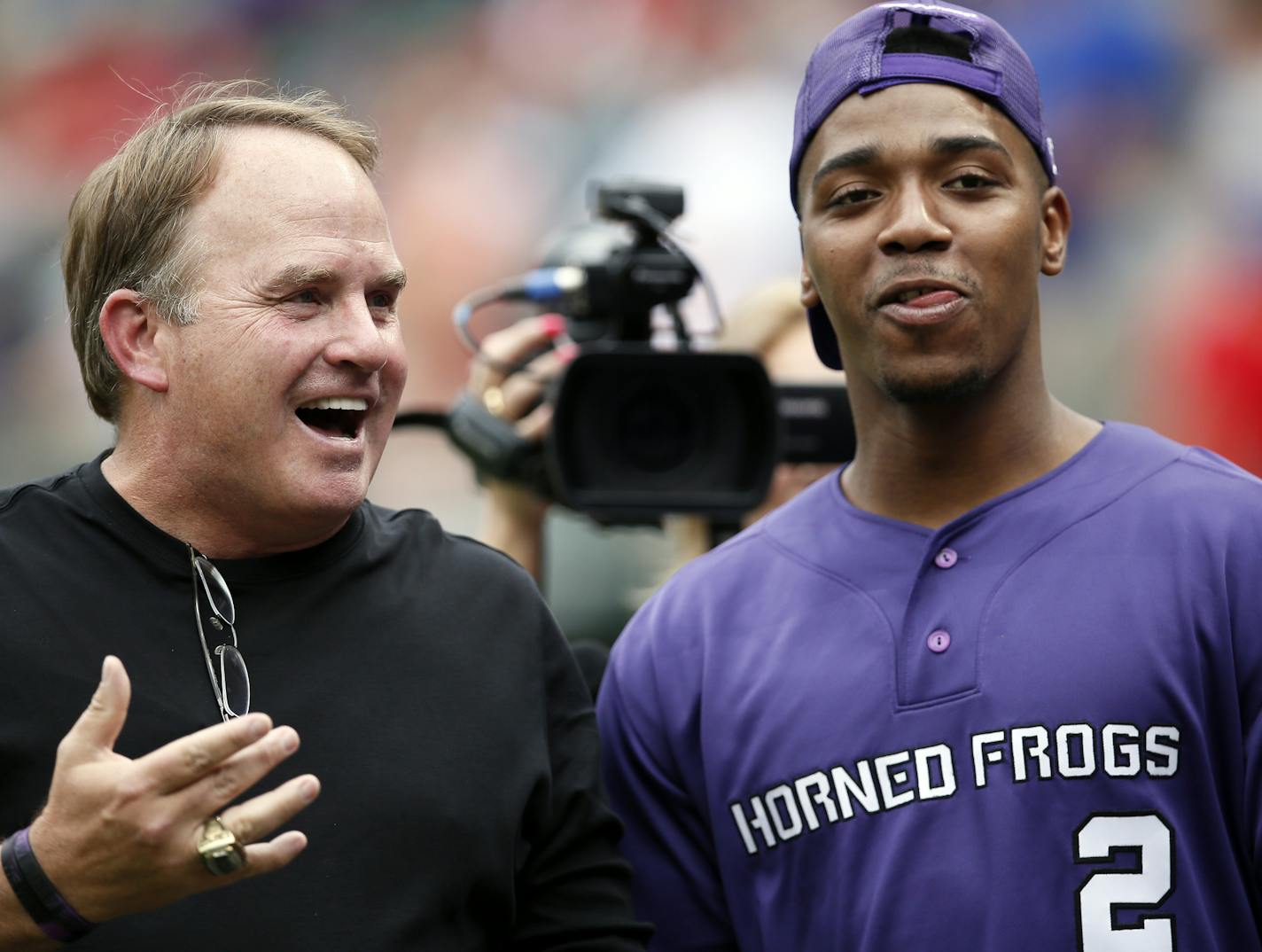 TCU head football coach Gary Patterson, left, and quarterback Trevone Boykin, right, talk on the field before Boykin threw out the ceremonial first pitch in an interleague baseball game between the Arizona Diamondbacks and Texas Rangers Wednesday, July 8, 2015, in Arlington, Texas. (AP Photo/Tony Gutierrez) ORG XMIT: OTKTG112