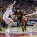 Minnesota's Jordan Murphy (3) drives between Wisconsin's Nate Reuvers (35) and Brevin Pritzl (1) during the first half of an NCAA college basketball g