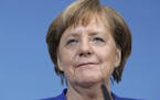 German Chancellor Angela Merkel smiles during a joint statement after the exploratory talks between Merkel's Christian Democratic block and the Social