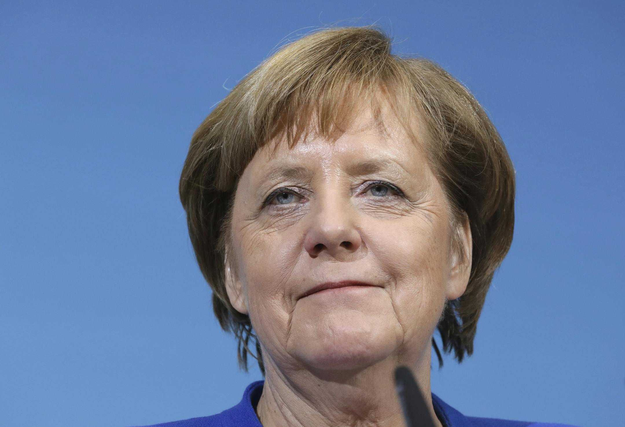 German Chancellor Angela Merkel smiles during a joint statement after the exploratory talks between Merkel's Christian Democratic block and the Social Democrats on forming a new German government in Berlin, Germany, Friday, Jan. 12, 2018. (AP Photo/Michael Sohn)