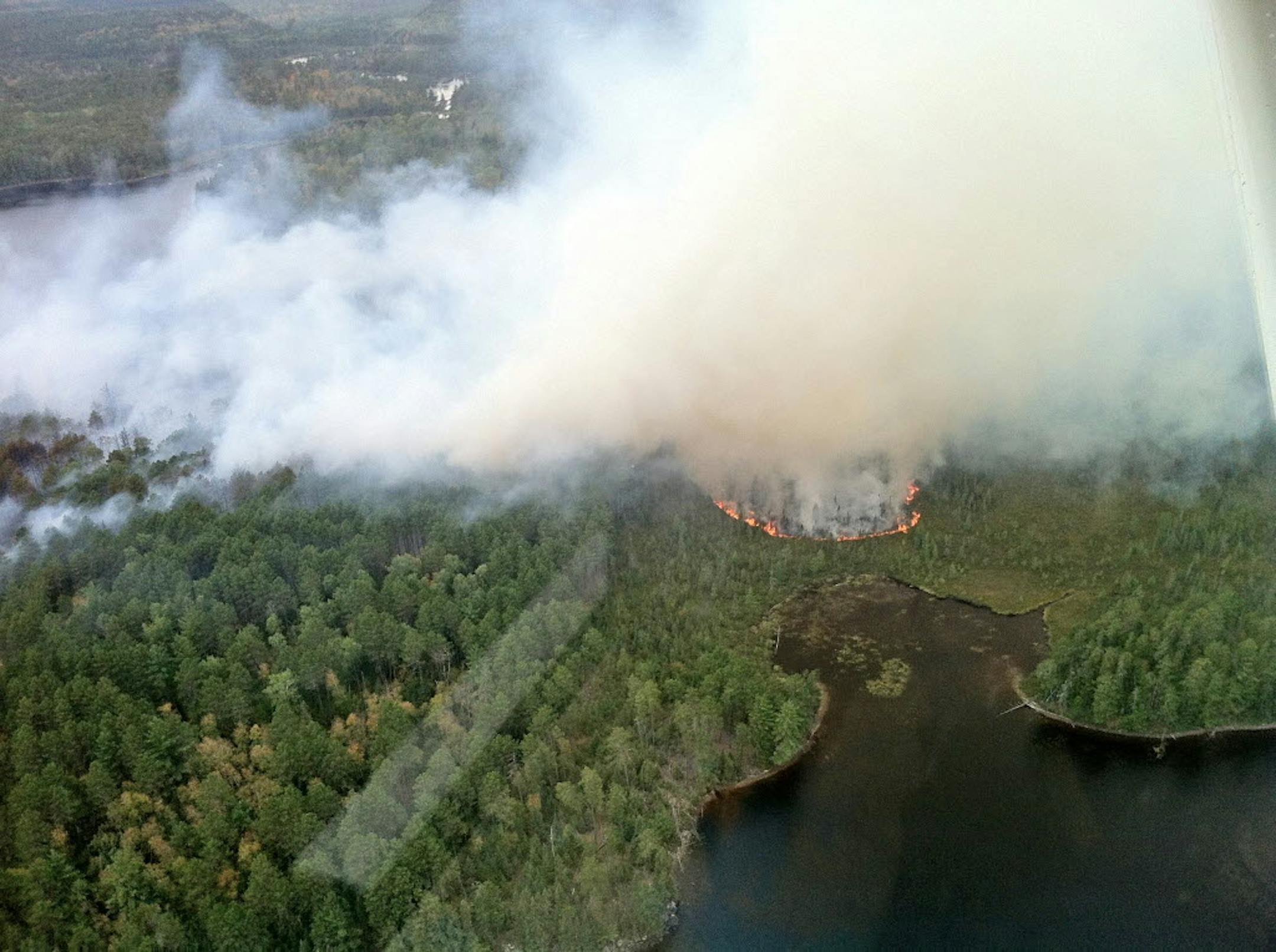 More than 30 acres of pine and spruce trees have burned in a wildfire in the Boundary Waters Canoe Area Wilderness northwest of Ely.