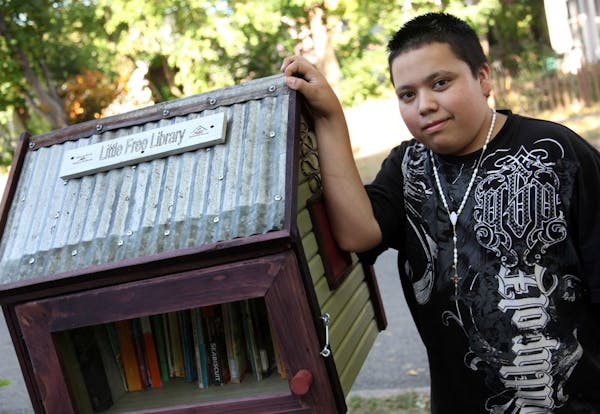Pedro Garcia, 14, built the Little Free Library box that stands outside Sage Holben's St. Paul home.
