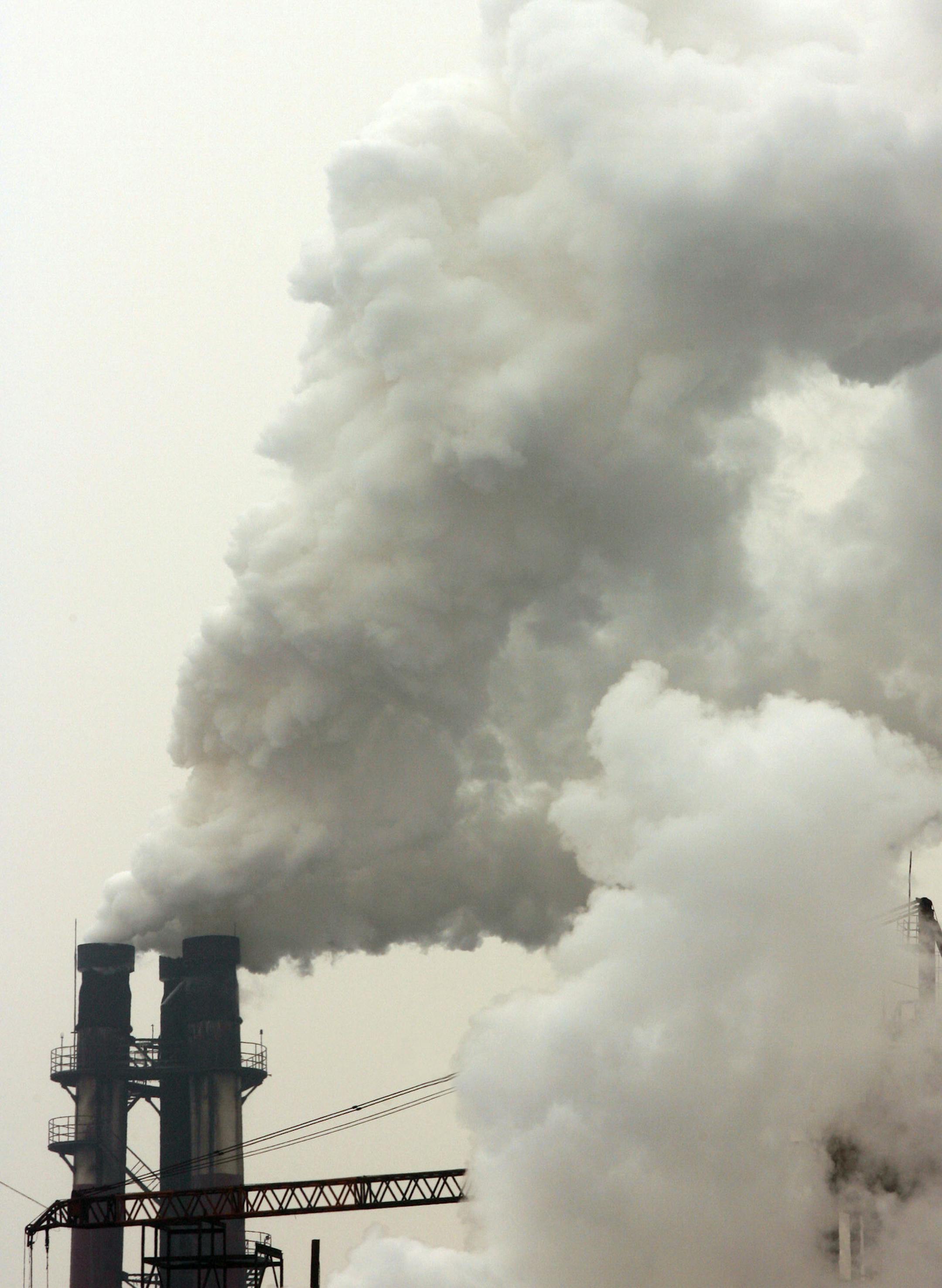 Smoke comes out of the chimneys of Beijing Shougang Co Ltd steel plant in Beijing, China, on January 11, 2006. Robin Howlett says Beijing was a city of blue skies and open roads when he arrived from the U.K. in 1988. These days, he rides his scooter wearing a surgical mask to keep out dust and fumes from the Chinese capital's 8,000 construction sites and more than 2 million vehicles. "It's bad, but this is my home," said Howlett, 38, a bar and restaurant owner. Pollution and traffic congestion a