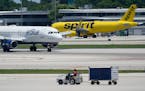 FILE - A JetBlue Airways Airbus A320, left, passes a Spirit Airlines Airbus A320 as it taxis on the runway, July 7, 2022, at the Fort Lauderdale-Holly