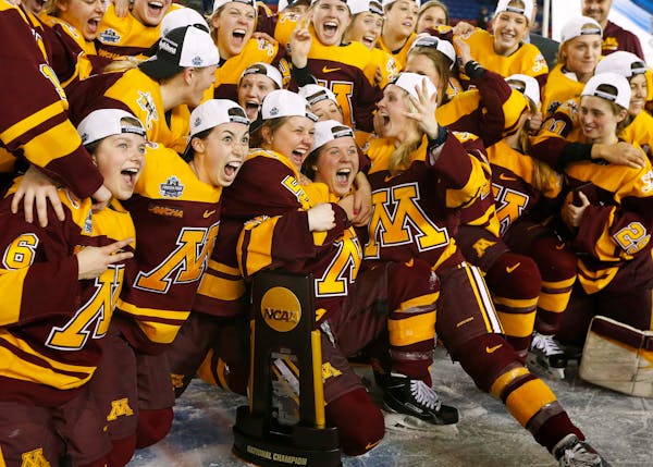 Gophers players celebrated with the trophy after defeating Boston College 3-1 in the Women's Frozen Four championship game in Durham, N.H., on Sunday.