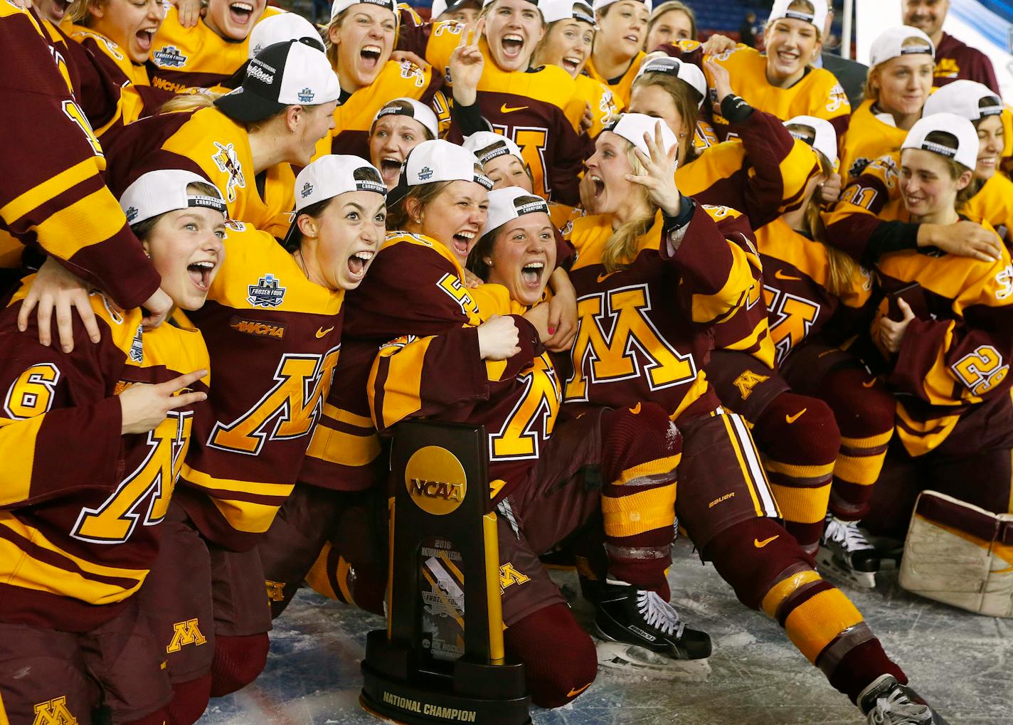 Gophers players celebrated with the trophy after defeating Boston College 3-1 in the Women's Frozen Four championship game in Durham, N.H., on Sunday.