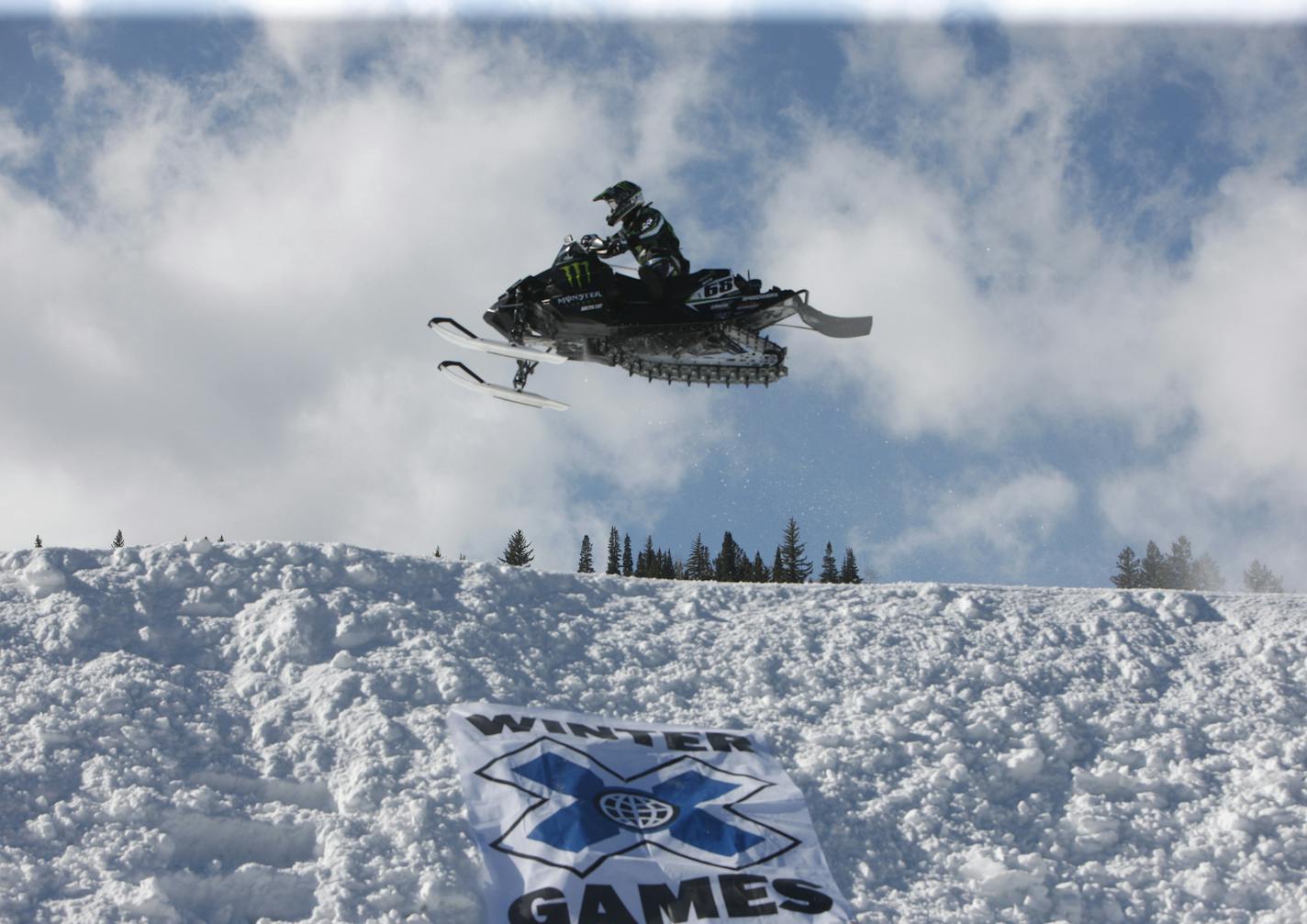 Tucker Hibbert flies over a jump in the snowmobile snocross final at the Winter X Games at Buttermilk Mountain outside Aspen, Colo., on Sunday, Jan. 31, 2010. (AP Photo/David Zalubowski) ORG XMIT: NYEOTK