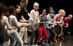 Students helped out with tug-of-war trying to separate two rubber disk during The University of Minnesota Physics Force team performance at Northrop A