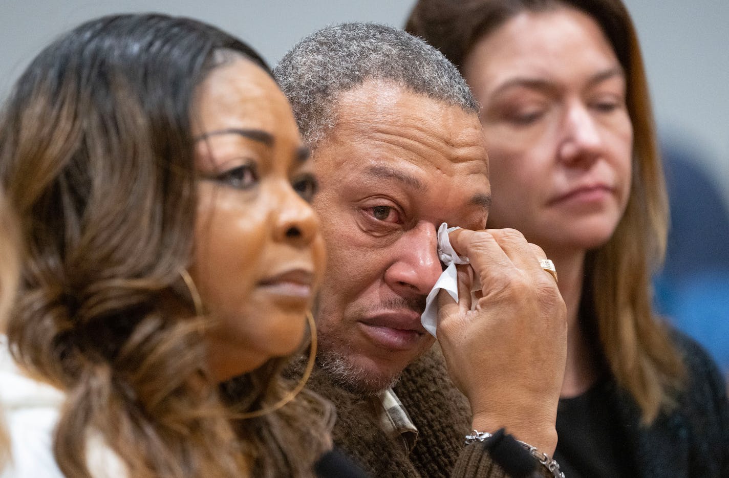 Terell Smith, the grandfather of Carlos Dickerson, wiped tears from his eyes during a Minnesota Board of Pardons hearing regarding Carlos Tuesday, Dec. 20, 2022 at the Senate Office Building in St. Paul, Minn. At the age of 14, Carlos Dickerson fatally shot another teenager during a botched drug deal in St. Paul. Dickerson was tried as an adult but has lived in an isolated unit of Lino Lakes prison, where minors convicted as adults must live until their 18th birthday. The board considered and approved a motion that will transfer Dickerson to Minnesota Correction Facility - Redwing where he can receive therapy, learn vocational skills and be with other inmates his age, until he turns 18. ]