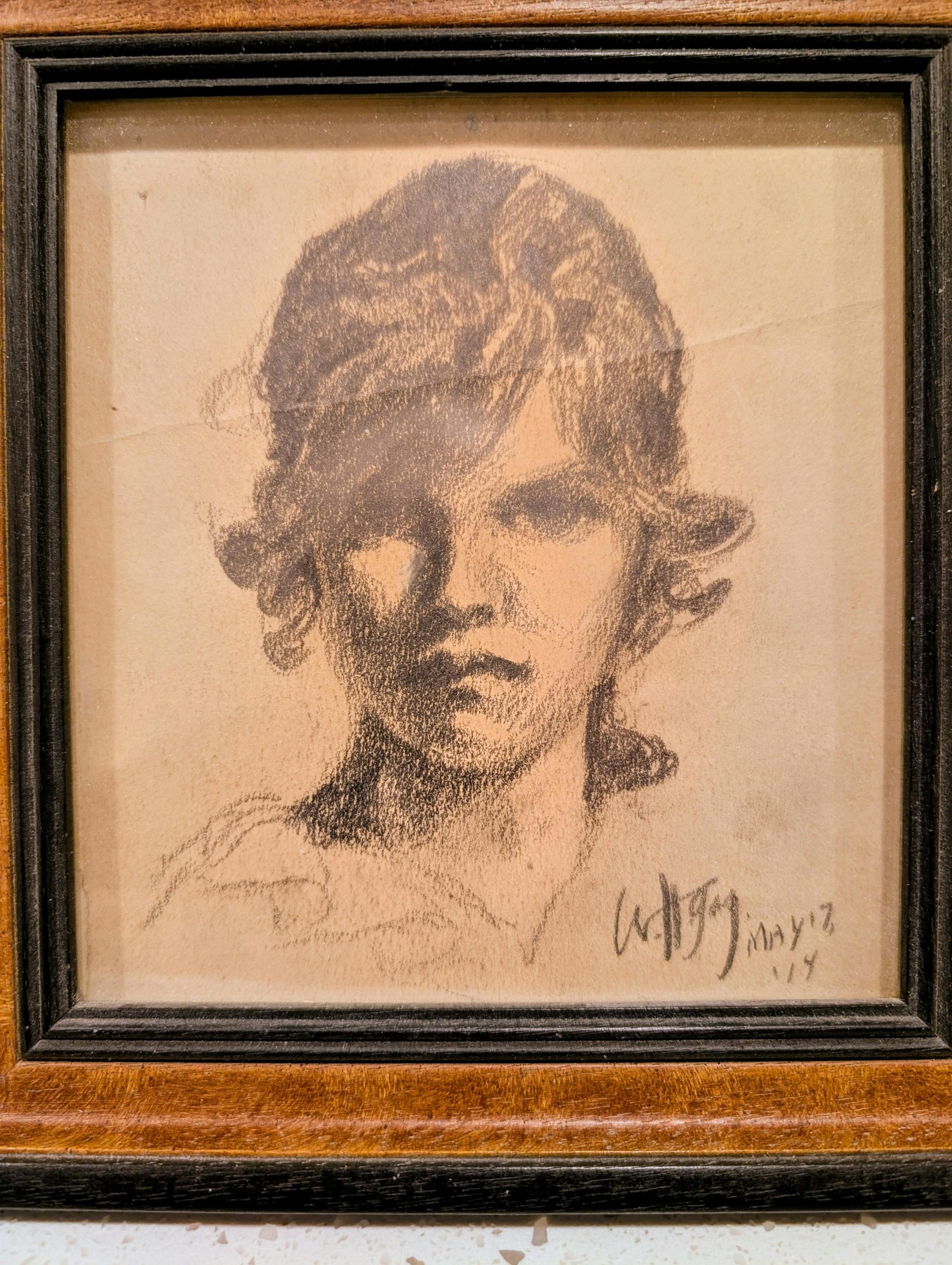 A charcoal drawing of a young woman, signed by Wanda Gág