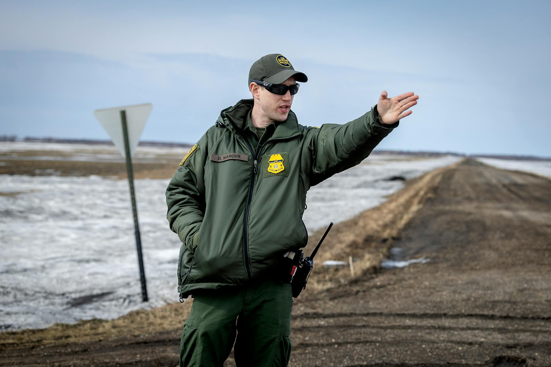 Customs and Border Patrol agent David Marcus looks for footprints near the site where two citizens from India and their human trafficker were found in the middle of a blizzard near Pembina, Minn., on Monday, March 21, 2022.