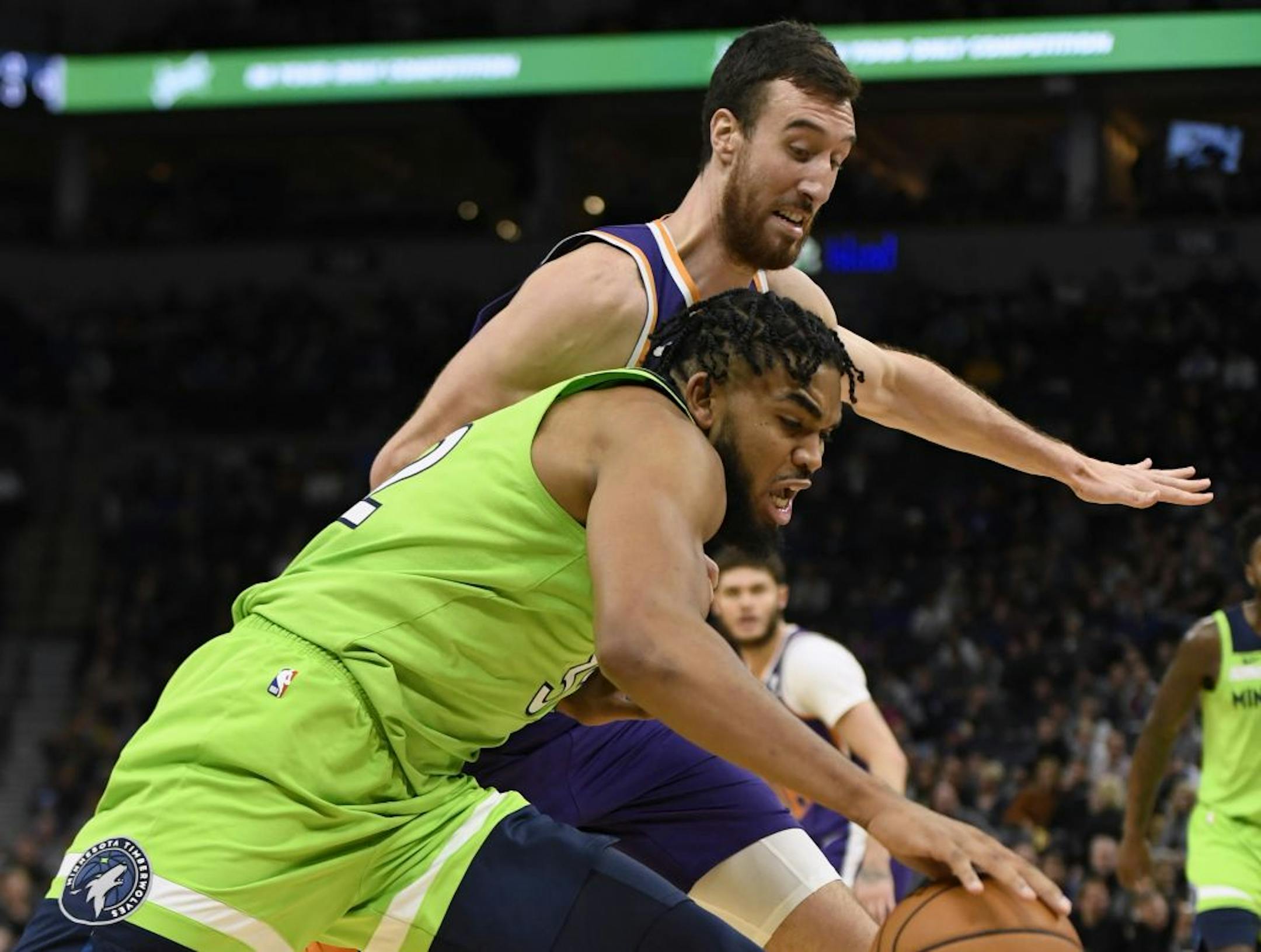 Phoenix Suns' Frank Kaminsky, behind, guards Minnesota Timberwolves' Karl-Anthony Towns during the fourth quarter of an NBA basketball game Saturday, Nov. 23, 2019, in Minneapolis. The Suns won 100-98.