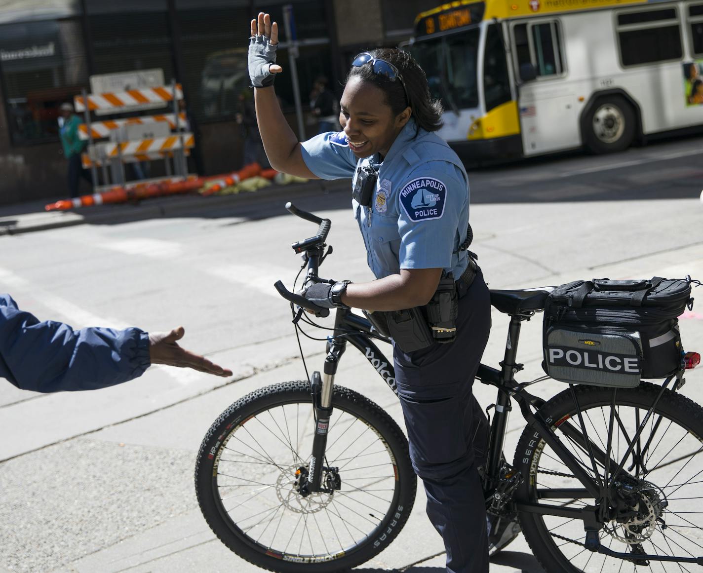 Minneapolis officer Yolanda Wilks gave a high-five to a woman telling her she had just passed a background check for a job.