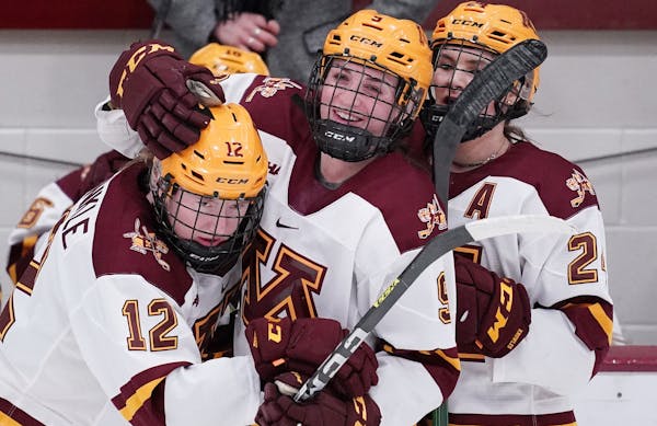 Gophers forward Grace Zumwinkle (12) got a hug from teammates during a home game earlier this season.