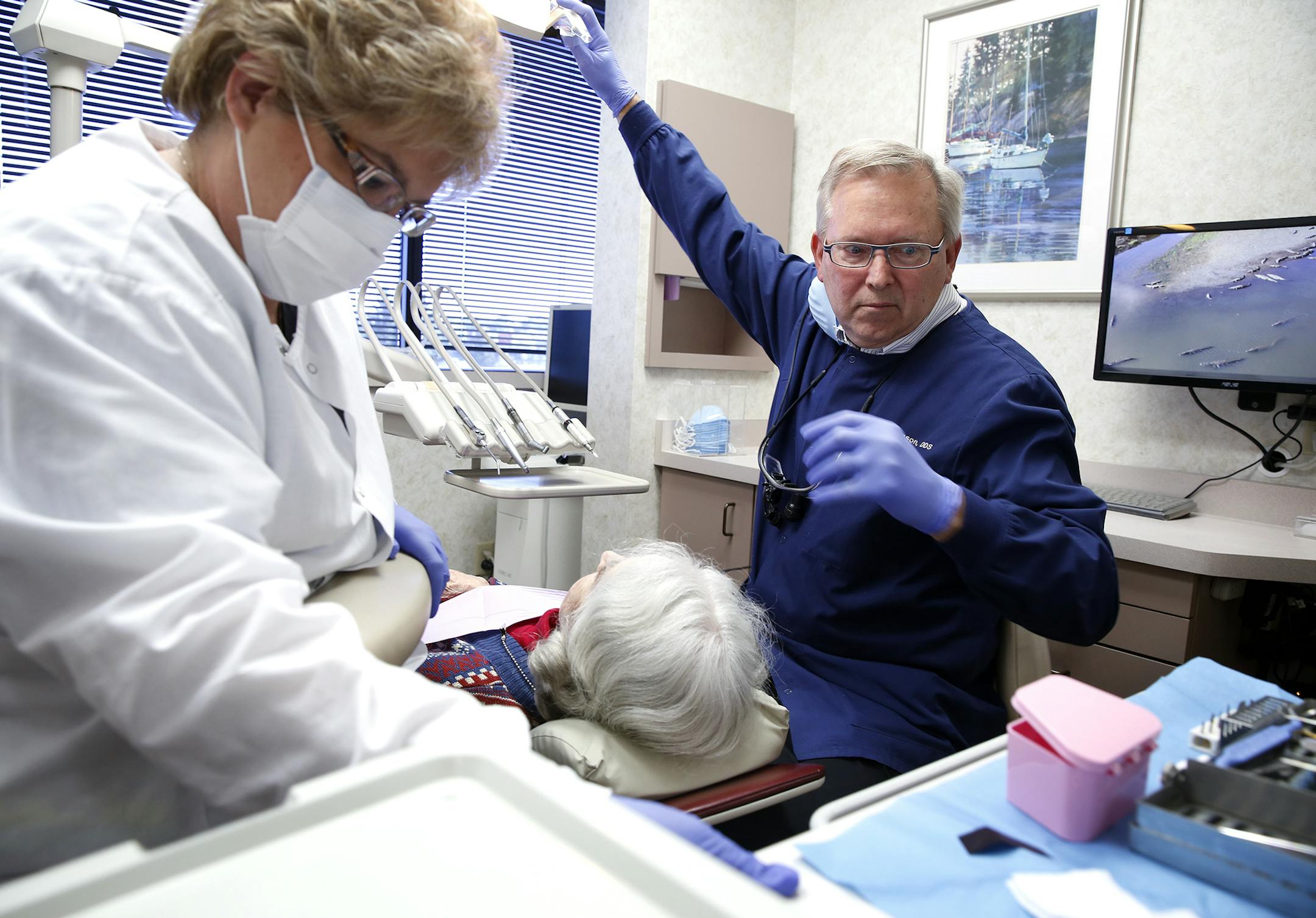 Dr. Keith Johnson, right, and Cindy Anderson, a certified licensed dental assistant, work on a dental patient at Stone & Johnson Dental Group in Edina, Minn. ] LEILA NAVIDI leila.navidi@startribune.com / BACKGROUND INFORMATION: Thursday, October 9, 2014. Stone & Johnson Dental Group in Edina is trying to figure out options now that their group's health insurance premium is set to jump by 28 percent because of the the federal Affordable Care Act.