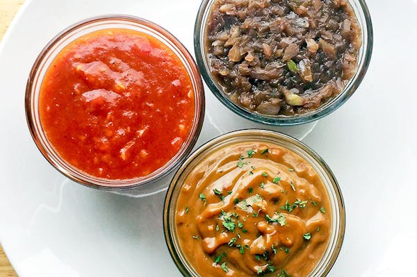 Clockwise from left: Spicy mango barbecue sauce, red wine sauce and peanut sauce.