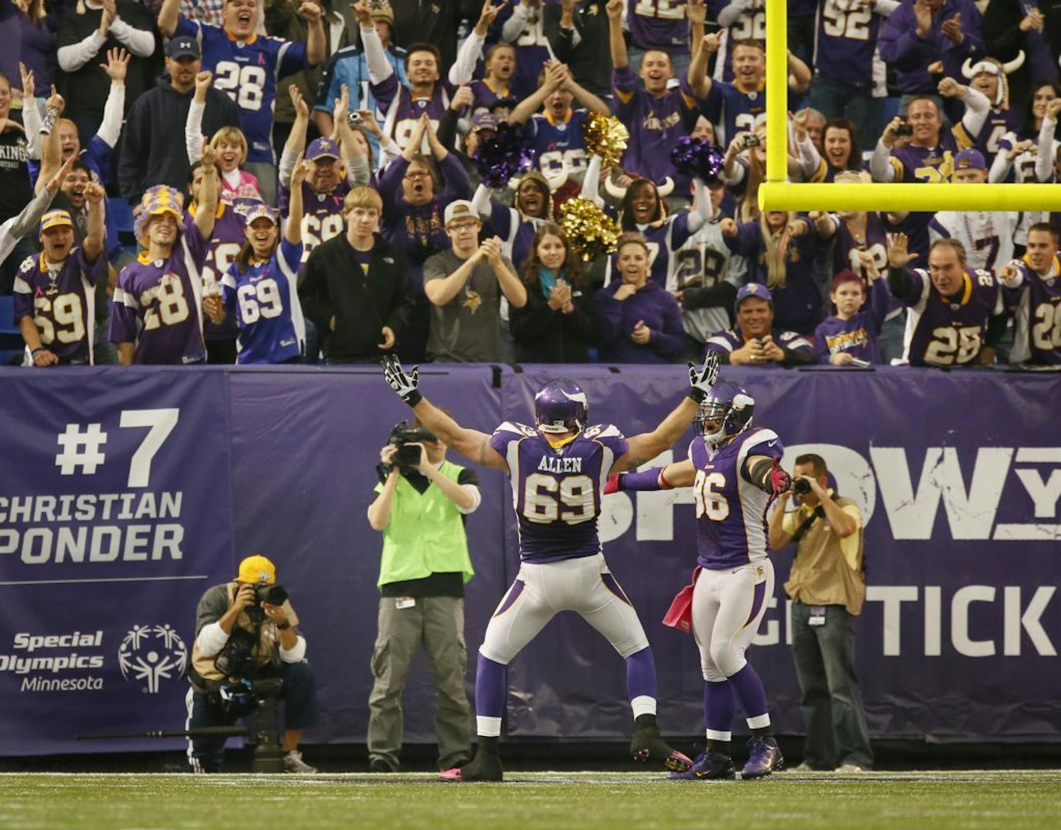 Vikings Jared Allen celebrates his sack with fans in the endzone.