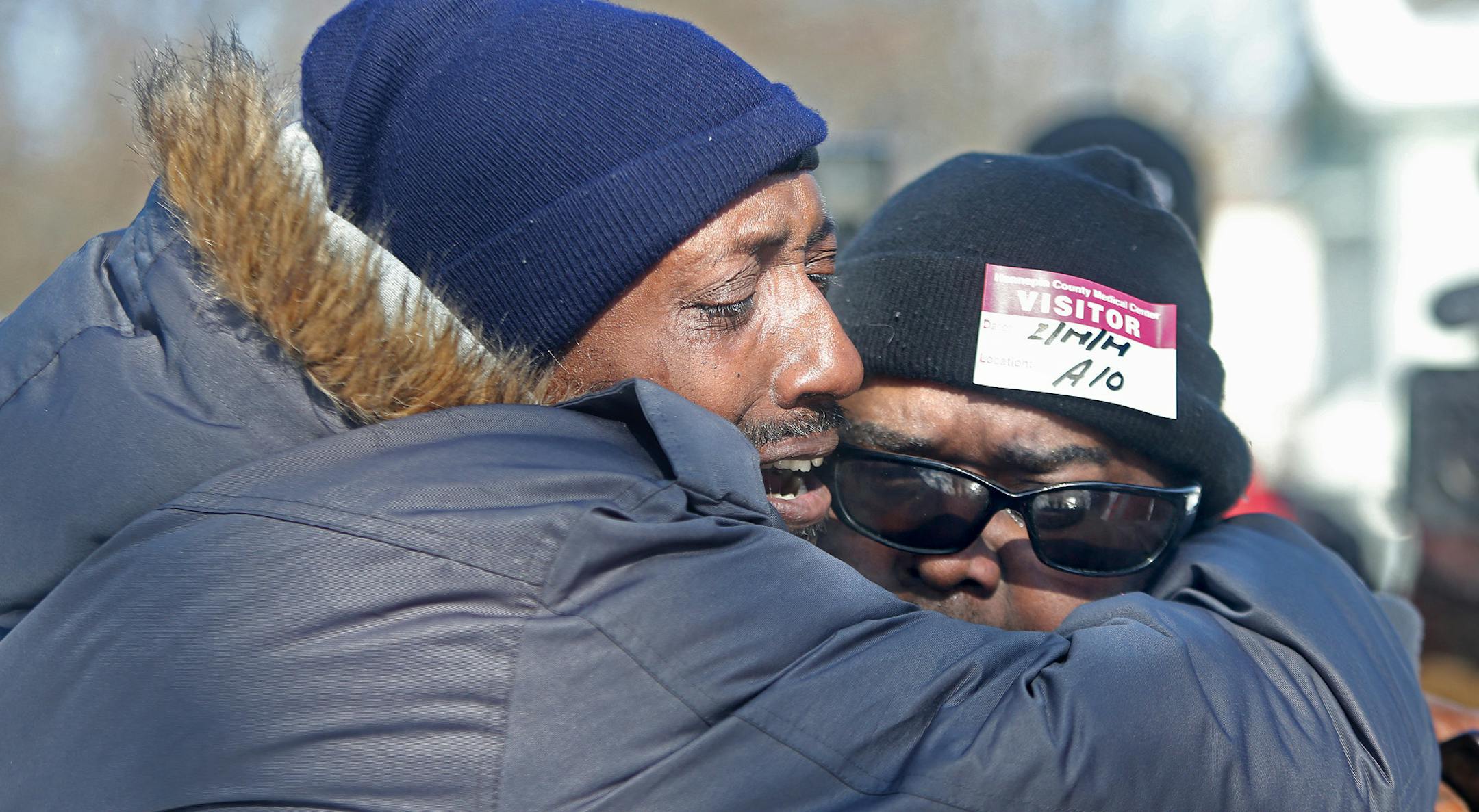 Regis Woodson, and Chris Anderson, neighbor and best friends to Troy Lewis, the dad who lost children, were overcome with emotion as they visited the home where a fire broke out early Friday, February 14, 2014 in Minneapolis, MN. Five children were killed in the blaze. (ELIZABETH FLORES/STAR TRIBUNE) ELIZABETH FLORES • eflores@startribune.com
