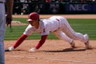 Los Angeles Angels' Shohei Ohtani dives back to first during the seventh inning of a baseball game against the Minnesota Twins Sunday, May 21, 2023, i